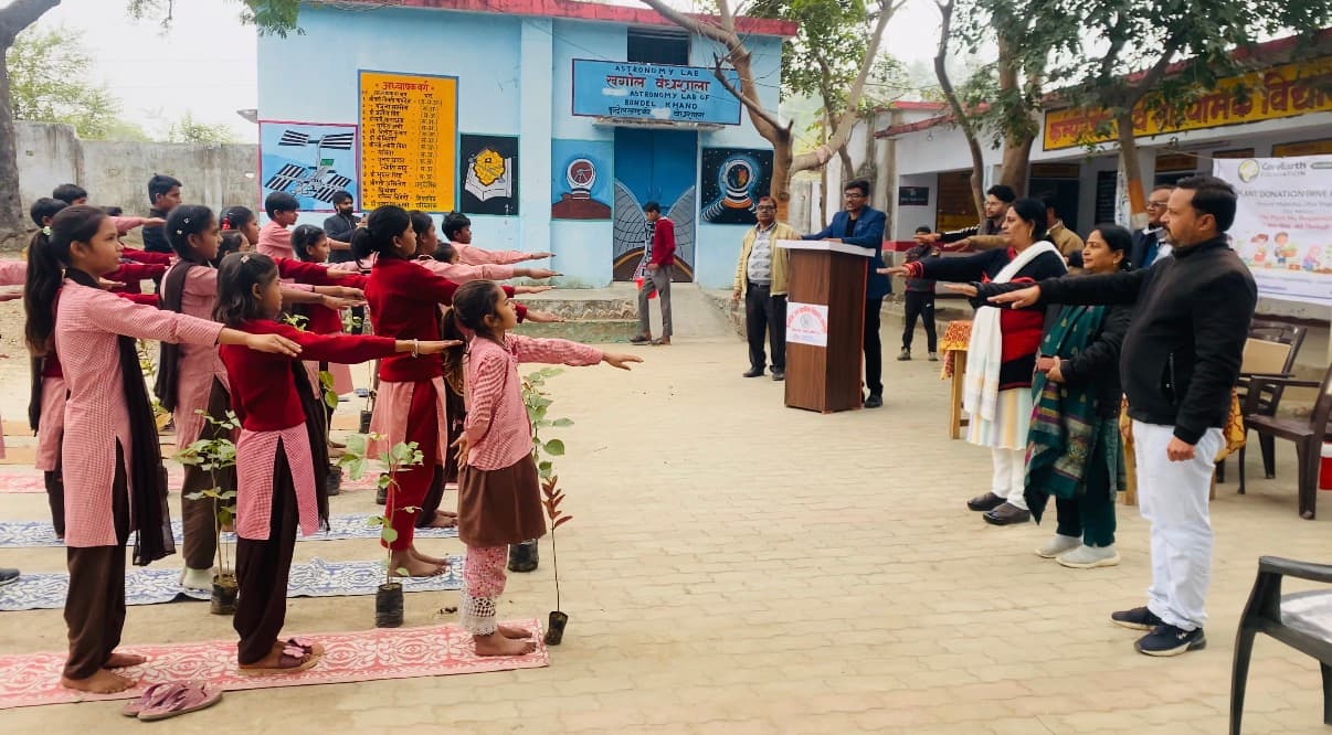 Students taking the plant-care pledge at a school drive in Mahoba